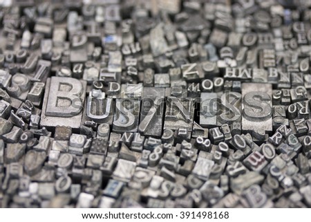 Close up of old used metal typeset letters with the word Business.