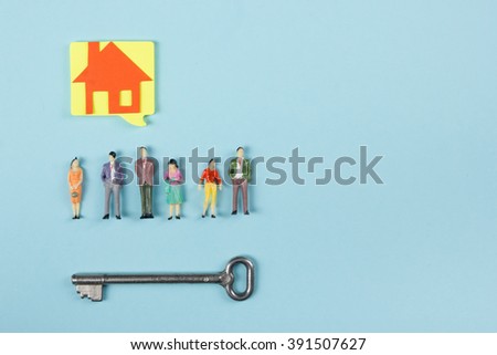 Real Estate concept. Blank speech bubbles and people toy figures Construction, building. Paper model house with key on blue background. Top view. Copy space for text.