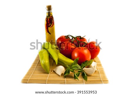 tomatoes, paprika and garlic with olive oil isolated on white background