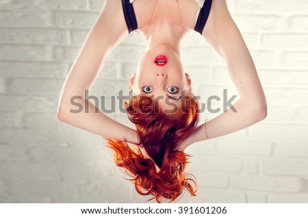 
Surprised green-eyed girl upside down Royalty-Free Stock Photo #391601206