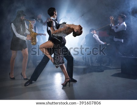 Dance couple dancing ballroom dancing to a live band sounds Royalty-Free Stock Photo #391607806