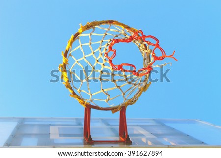 The basketball hoop with blue sky from the worm eye-view, selective focus