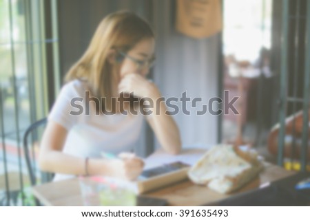 education concept - indoor picture of bored and tired woman taking notes. Vintage tone. Focus blur