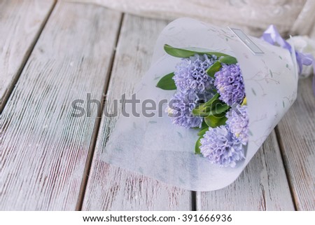 Background with fresh pink, violet and blue  hyacinths on    wooden planks. Selective focus. Place for text. Square image.