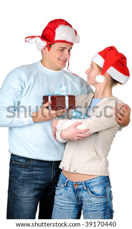 Young couple  in santa's hats holding gift boxes isolated on white background