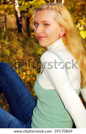 Young pretty woman in the autumn park.