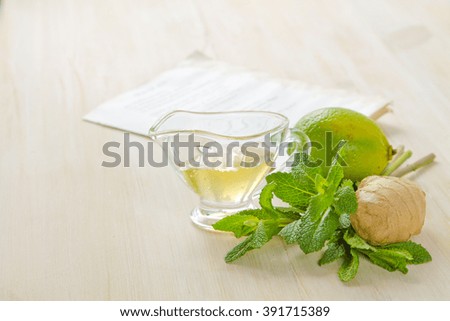 Lime, ginger, honey and mint on a white wooden table