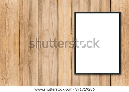 Mock up blank poster picture frame on wood wall.