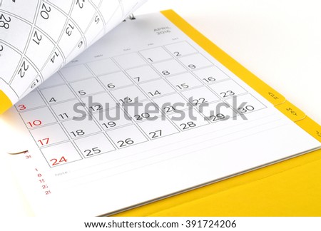 close-up cardboard desk calendar with days and dates of April 2016 in grid and blank lines for text notes, reminder monthly business planning or meeting deadline, flip the calendar page Royalty-Free Stock Photo #391724206