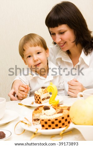 Boy celebrating second birthday with his mother