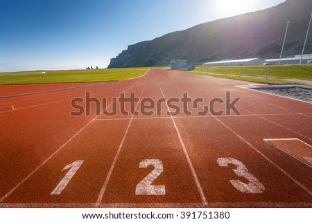 Photo of running track outdoors with beautiful nature 