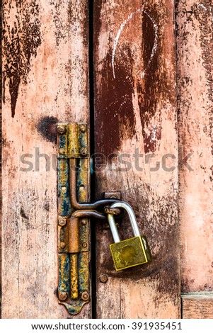 Old lock on old wood texture backgrounds.