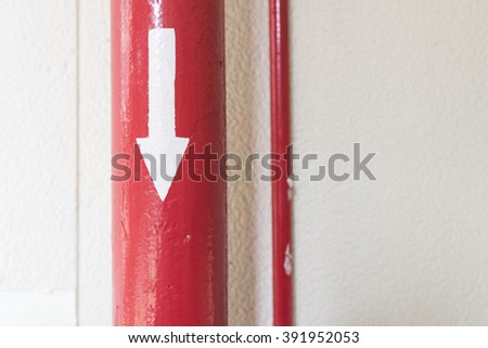 Red pipe have arrow on it and pointing direction