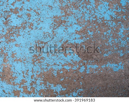 Old cracked blue paint on the concrete. Grungy wall background