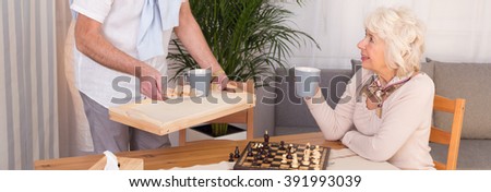 Cropped picture of an elderly couple playing chess and drinking tea