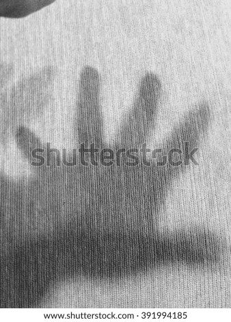 Shadow of left hand, sign "wait! and help!", black and white, monochrome and noir