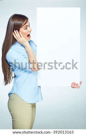Surprised emotional business woman hold big sign board. Isolated studio portrait.