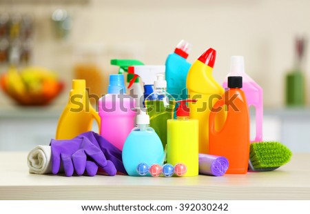 Cleaning set with products and tools on kitchen table Royalty-Free Stock Photo #392030242