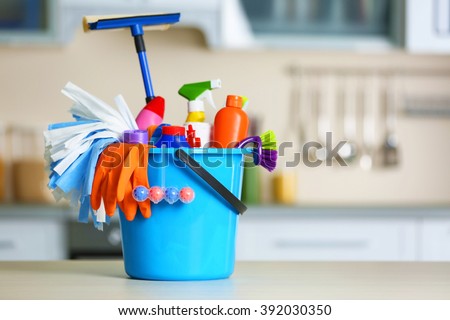 Cleaning set with products and tools in blue bucket Royalty-Free Stock Photo #392030350
