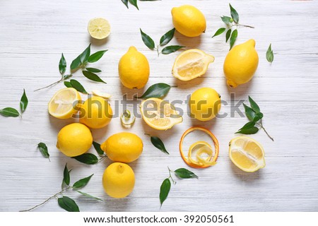 Pile of lemons on wooden table Royalty-Free Stock Photo #392050561