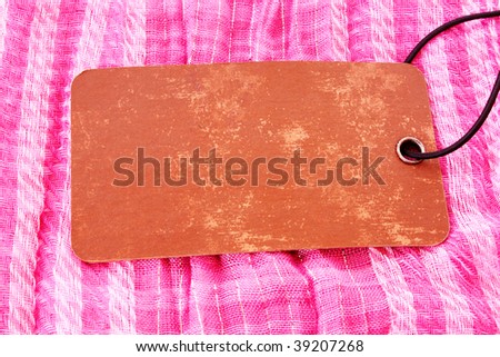 Label on pink textile background