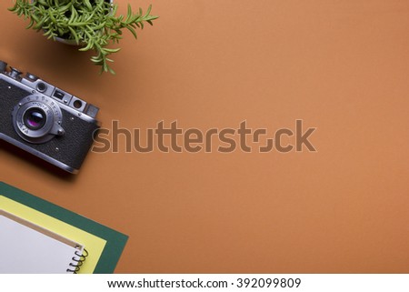 Tourism, travel concept. Office desk table with notepad, camera and supplies. Top view. Copy space for text.