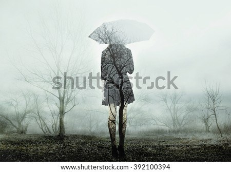 Woman with umbrella standing on the field with trees. The image with the effect of double exposure Royalty-Free Stock Photo #392100394