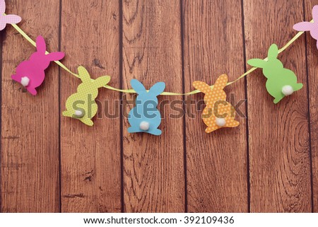 Easter bunnies hanging on a wooden background