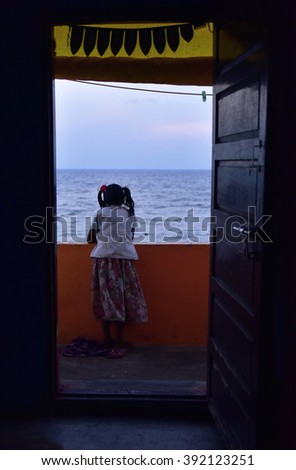 A girl searching herself in the sea breeze. 