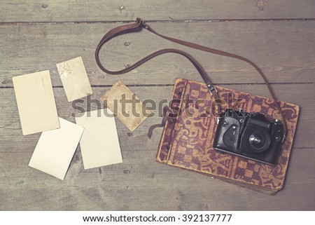 old retro camera on vintage photo album and blank pictures