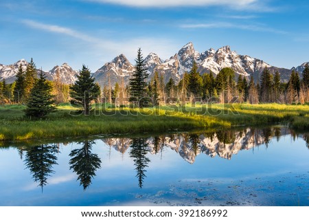 A Mountain Range with Its Reflection, Grand Teton National Park, USA.  Landscape is unique and part of Rocky Mountain. Grand Teton National Park is also popular among landscape and nature photographer Royalty-Free Stock Photo #392186992