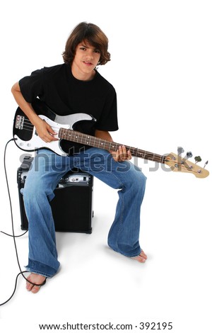 Native American teen boy child sitting on amplifier playing electric bass guitar over white.