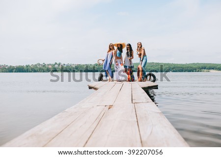 four beautiful girl friends on the dock
