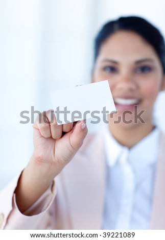 Ethnic businesswoman holding a white card in office