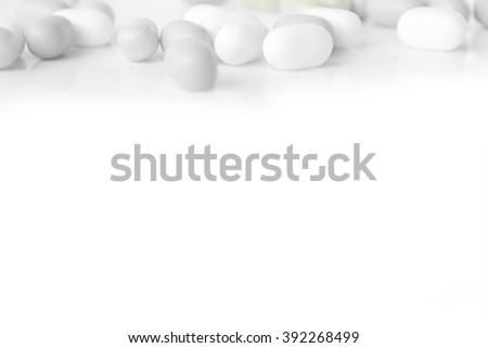 white and gray capsules on the white background