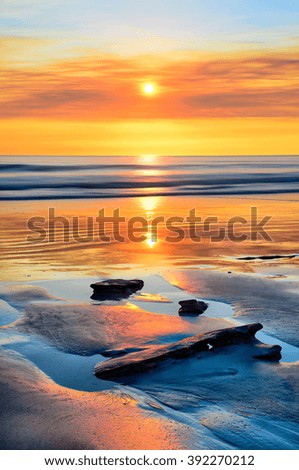 Beautiful sunset on a beach of Broome, Australia.  Colorful sky with its reflection.
