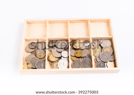 coins money in the wooden box with white background