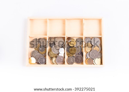 coins money in the wooden box with white background