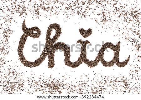 top view macro shot of handwriting vintage style word, surrounding by dust made of chia seeds, vegan gluten-free organic healthy superfood, isolated on white background.