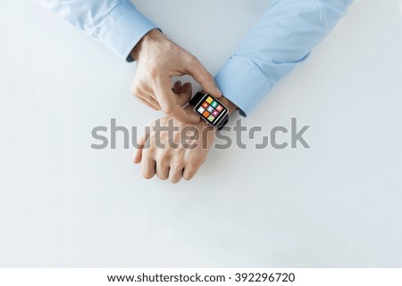 business, technology and people concept - close up of male hands setting smart watch with application icons on screen Royalty-Free Stock Photo #392296720