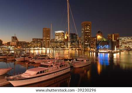 foreground of yachts with the Baltimore skyline at dusk behind