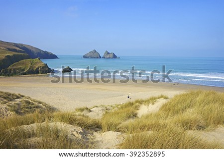 Sand dunes and a view of the beautiful large sandy beach at Holywell beach and bay on a winter day near Newquay on the North Cornish coast, Cornwall, England, UK Royalty-Free Stock Photo #392352895