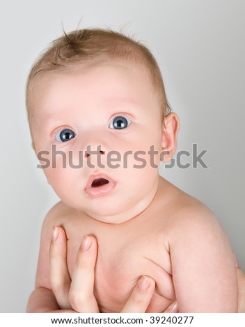 Beauty baby boy at mother hand isolated on a white background