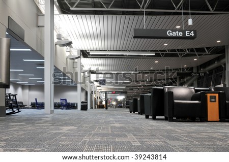 Airport terminal interior with no people showing the various gates information