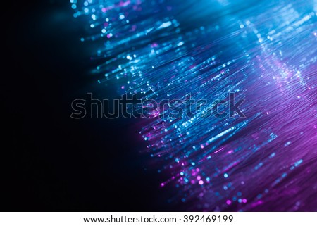 blue violet light fiber optic, high speed technology of digital telecommunication. Royalty-Free Stock Photo #392469199