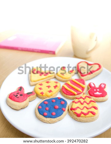 colorful easter cookies on white plate