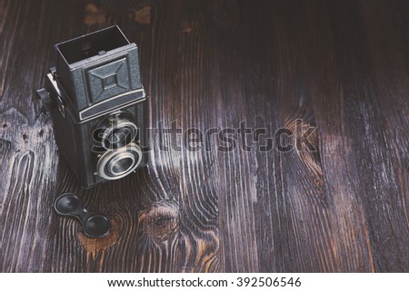 Old medium format camera on a wooden background