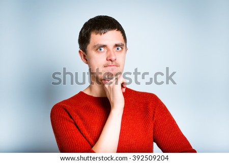 businessman has a good idea and touching chin, isolated on a gray background