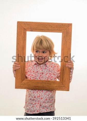 child looking through a frame