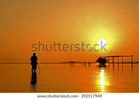 Silhouette of photographer during sunrise.